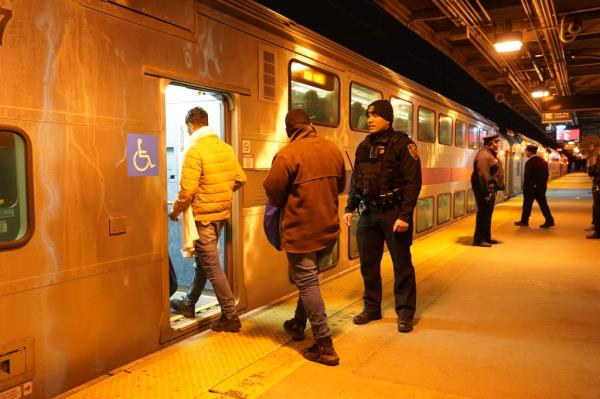 Migrants led o<em></em>nto Manhattan trains. 